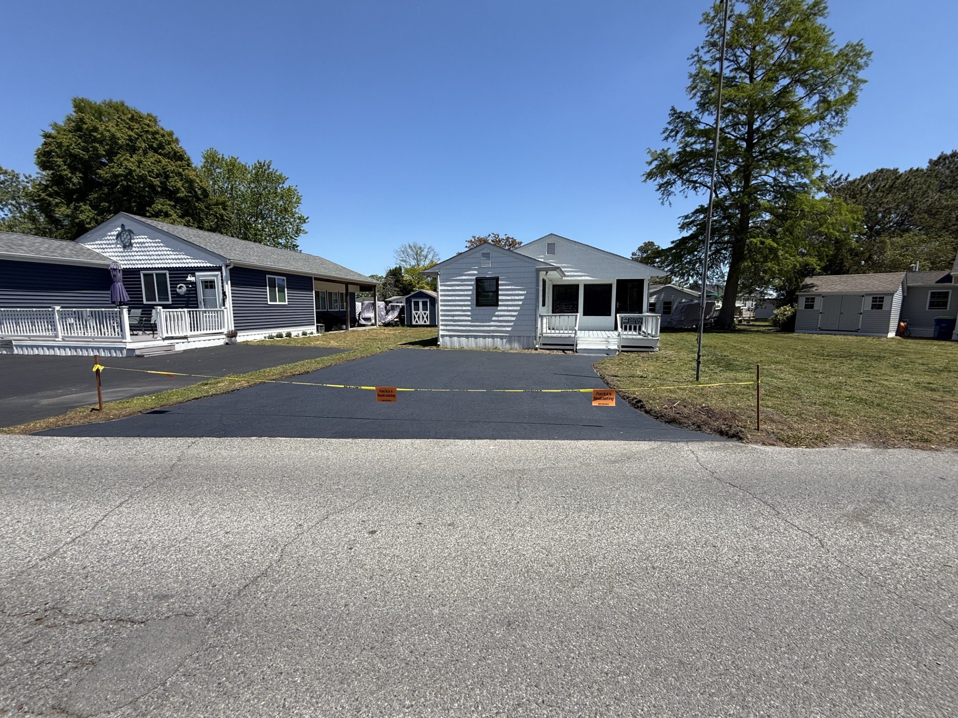 Same driveway after sealcoating, deep black finish